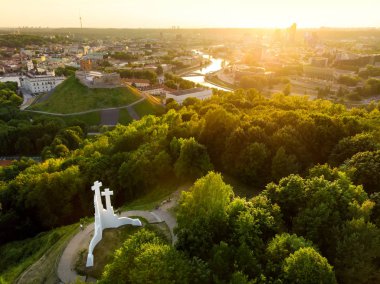 Aerial view of Three Crosses monument overlooking Vilnius Old Town  clipart