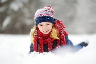 Sevimli küçük kız güzel kış Park eğleniyor. Bir karda oynayan sevimli çocuk. Çocuklar için kış aktiviteleri