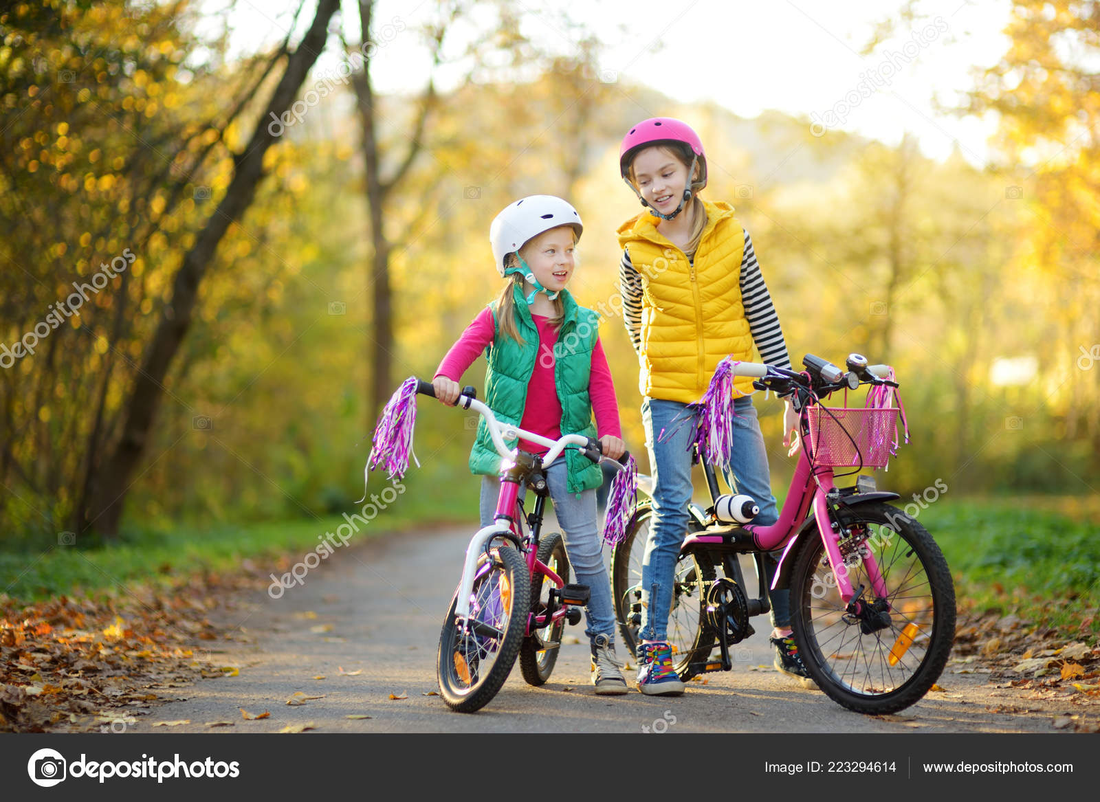 Girls Kids Riding A Bike Children Learning To Drive A Bicycle On A