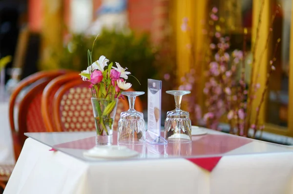 Small table set for dinner in outdoor cafe in Little Italy neighborhood in downtown Manhattan