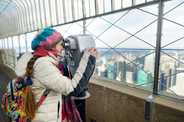 Young woman tourist at observation deck of Empire State Building in New York City