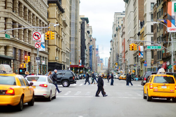 NEW YORK - MARCH 16, 2015: People crossing street in downtown Manhattan