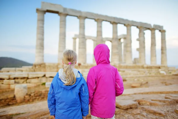 Deux sœurs explorant le temple grec antique de Poséidon au cap Sounion, l'un des principaux monuments de l'âge d'or d'Athènes . — Photo