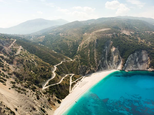 Veduta aerea della spiaggia di Myrtos, la spiaggia più famosa e bella di Cefalonia, una grande costa con acqua turchese e sabbia bianca grossolana, circondata da ripide scogliere . — Foto Stock