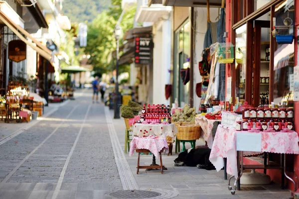Various goods sold at small shops at the pedestrian area at center of Kalavryta town near the square and odontotos train station, Greece.