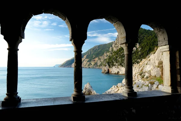 Columns of famous gothic Church of St. Peter with beautiful shoreline scenery in Porto Venere village, Liguria, Italy Stock Picture