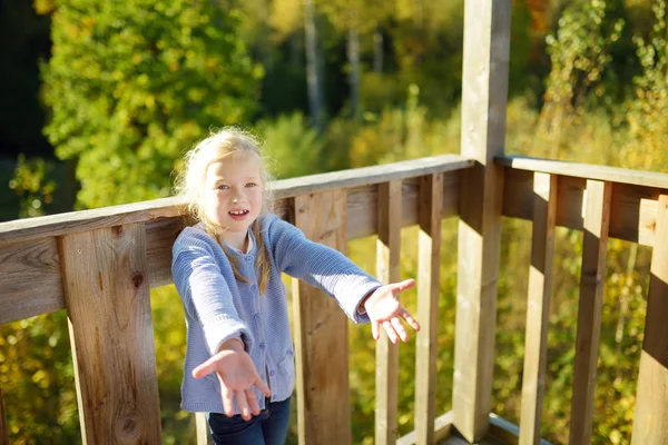 Cute young girl having fun during forest hike on beautiful summer day. Child exploring nature. — Stock Photo, Image