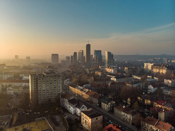 Beautiful foggy Vilnius city scene in autumn. Aerial early morning view. Fall city scenery in Vilnius, Lithuania.