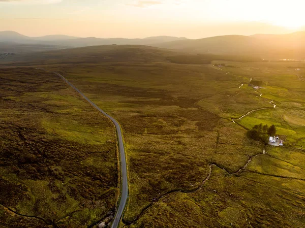 アイルランドのコネマラ地方の夕日の眺め。地平線上の壮大な山々と風光明媚なアイルランドの田園風景, 郡ゴールウェイ, アイルランド. — ストック写真