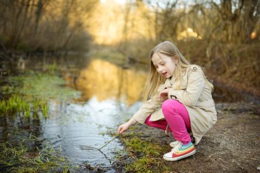 Güzel, güneşli bahar gününde eğlenen tatlı bir genç kız. Çocuklarla aktif aile eğlencesi. Aile eğlencesi..