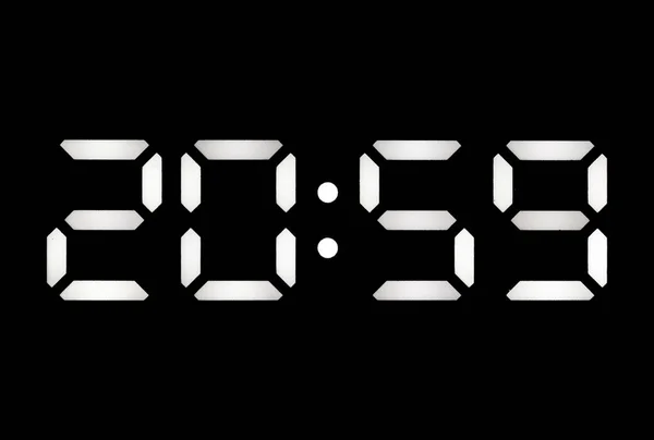 Real white led digital clock on a black background showing time 20:59