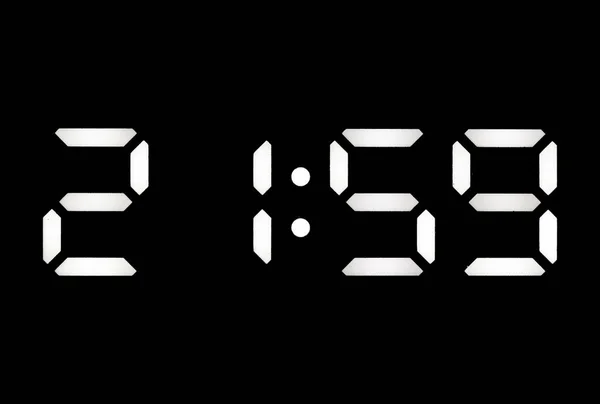 Real white led digital clock on a black background showing time 21:59