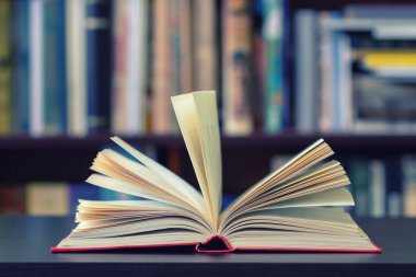 Kitap rafı arka plan üzerine açık bir kitap.