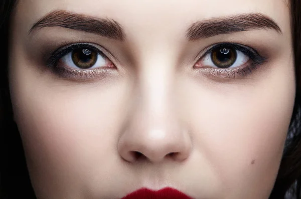 Closeup macro portrait of female face. Human woman face  with day beauty makeup. Girl with perfect skin.