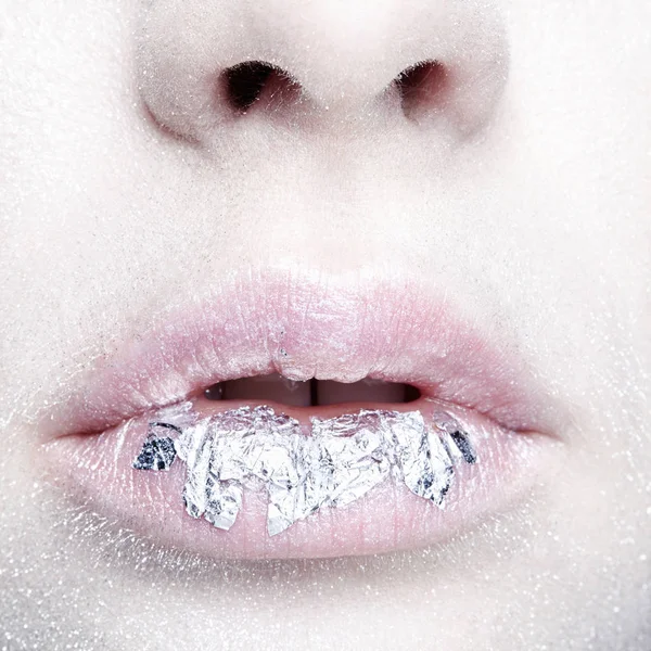 Female mouth with sparkles on lips. Closeup macro beauty portrait of young woman face.