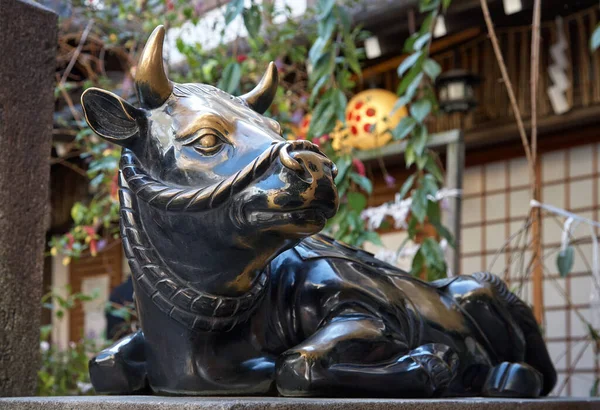 The metal statue of Temmangu Ox, the messengers of God of learning Tenjin (Sugawara Michizane) at Nishiki-Tenmangu Shrine in the center of Nishiko Market. Kyoto. Japan
