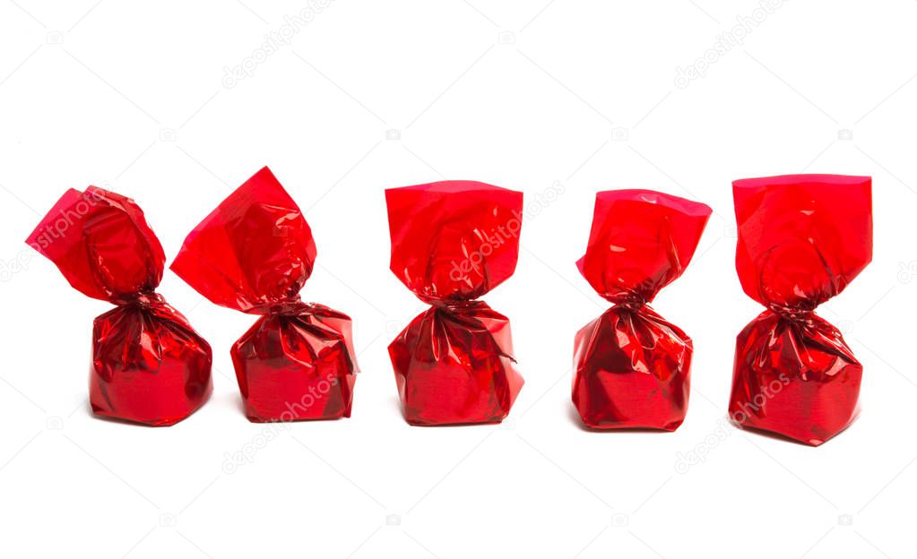 Chocolate candy in a wrapper isolated on white background