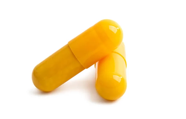 Yellow capsules isolated — Stock Photo, Image