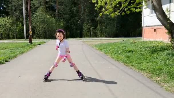 Little Girl Rides Roller Skates Outdoor — Stock Video