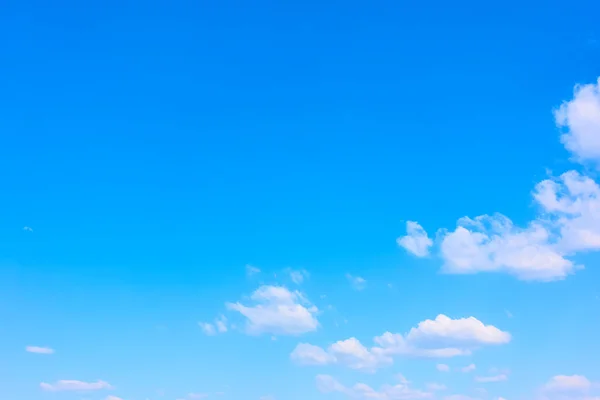 Blue spring sky with white clouds - natural background with large space for your own text