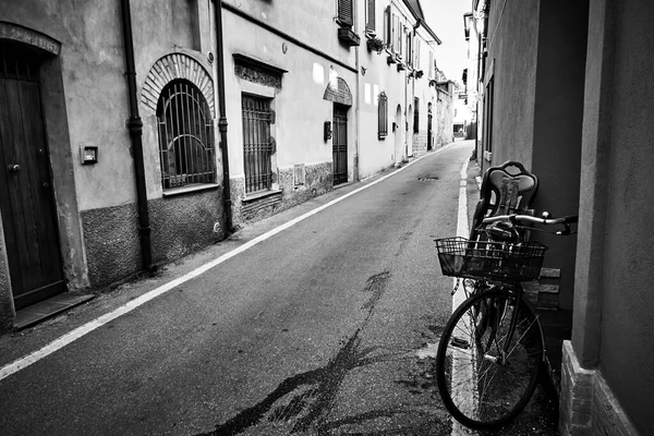 Perspective of a side street in Rimini, Italy. Italian cityscape, black and white urban photography