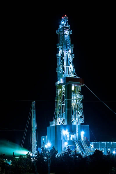 Oil and Gas Drilling Rig at night. Oil drilling rig operation on the oil platform.