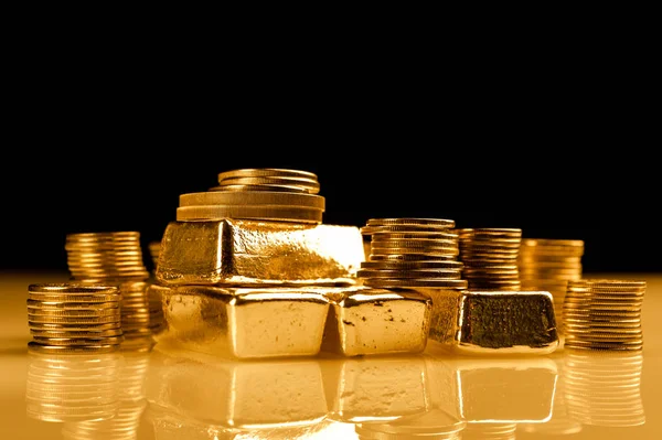 Gold bullions and stack of coins. Background for finance banking concept. Trade in precious metals.