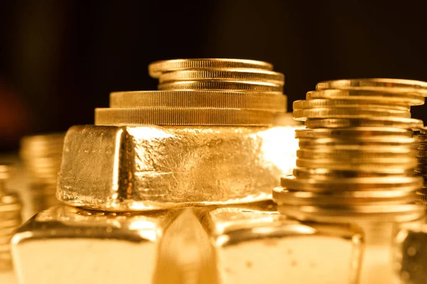 Gold bullions and stack of coins. Background for finance banking concept. Trade in precious metals.