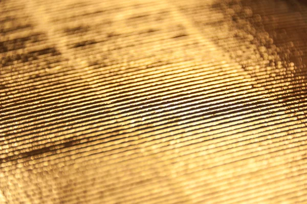 Texture luxueuse en papier ondulé doré pour fond, motif abstrait doré . — Photo