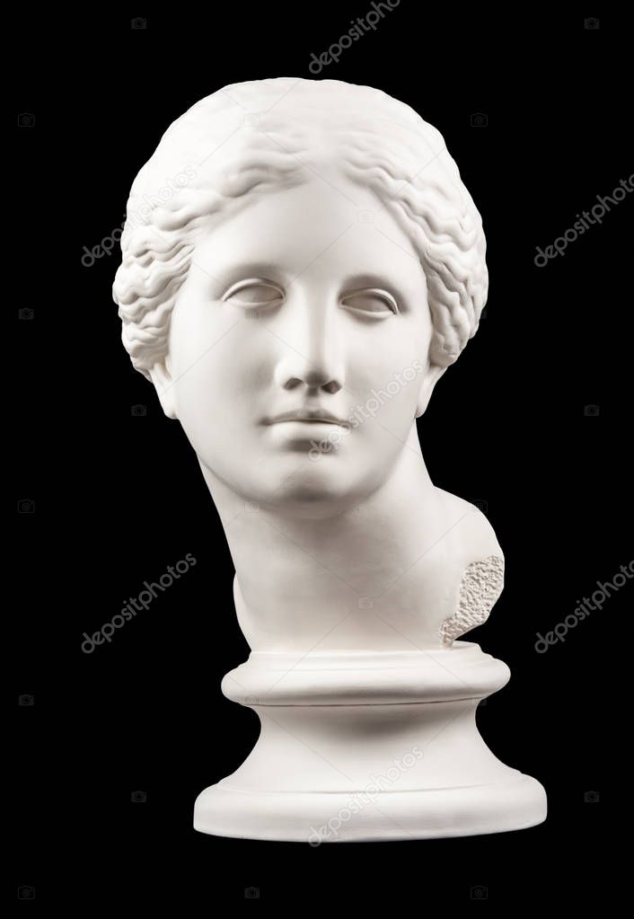 Gypsum copy of ancient statue Venus head isolated on black background. Plaster sculpture woman face.