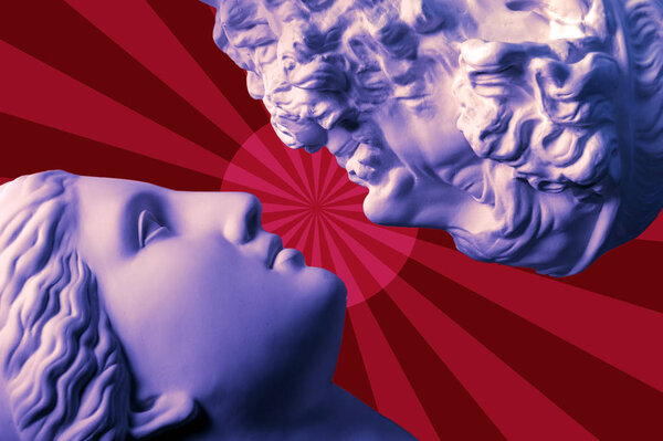 Antique statues of woman and man heads close up on a red background. Concept of music, style, vintage, love.