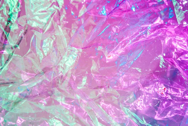 Fond holographique dans le style des années 80-90. Texture réelle du film de cellophane dans des couleurs acides vives. — Photo