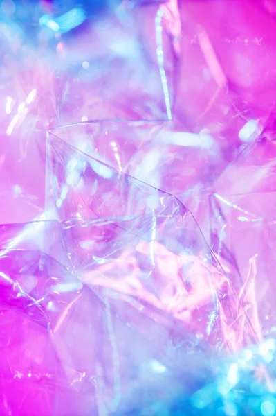 80-90 'ların tarzında holografik arkaplan. Parlak asit renklerinde selofan filmin gerçek dokusu.