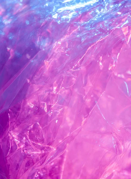 Голографический фон в стиле 80-90-х годов. Реальная текстура целлофановой пленки в ярко-кислотных цветах. — стоковое фото