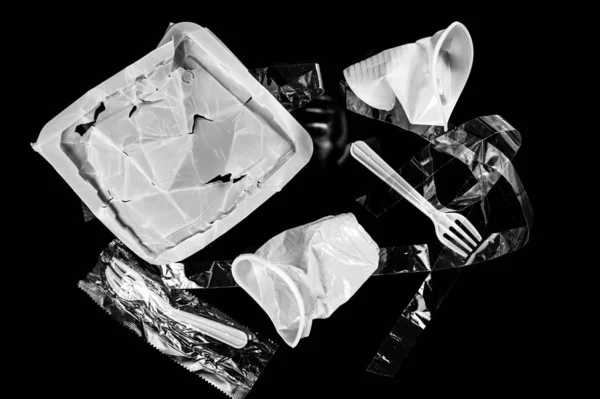 Various disposable crumpled plastic garbage isolated on a black background. Concept of recycling plastic and ecology. — ストック写真