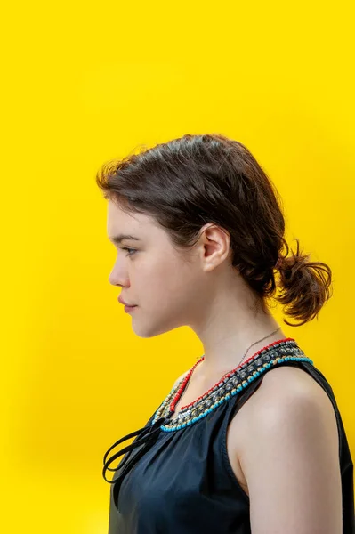 Närbild mode porträtt vacker ung brunett kvinna på gul bakgrund. Kopiera utrymme. — Stockfoto