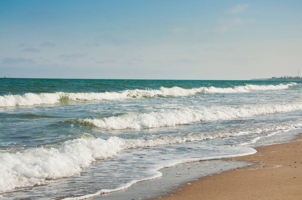 Beautiful seascape. Sand beach, clear blue water and waves. Black Sea, Zatoka, Odessa region, Ukraine