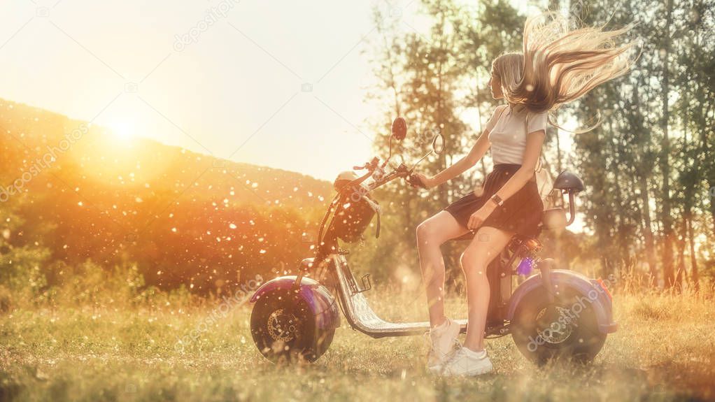 Young Woman Riding Electro Scooter On Country Road