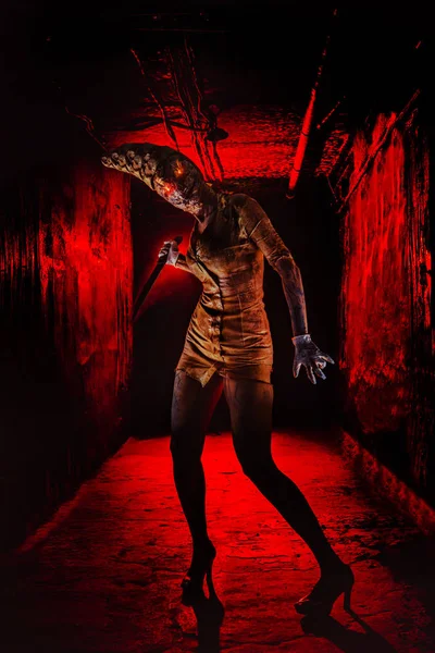 Scary undead zombie woman in the dark corridor. Halloween theme. — Stock Photo, Image