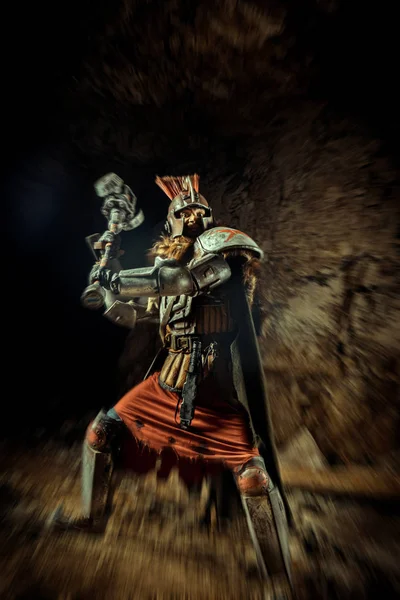 一个身披盔甲、身披铁锤的骑士的袭击 以地下城为背景. — 图库照片