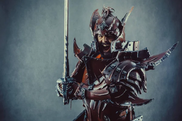 剣で鎧の強力な騎士 暗い背景 — ストック写真