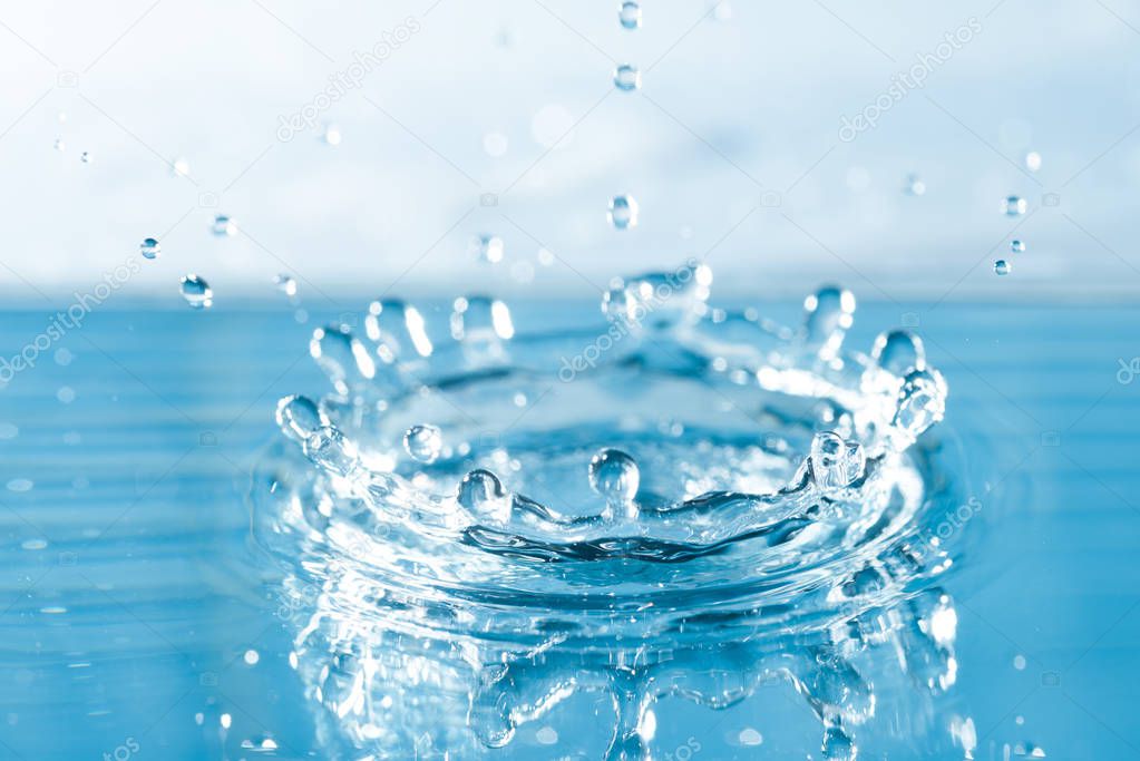 blue colored water drop splash, close up view