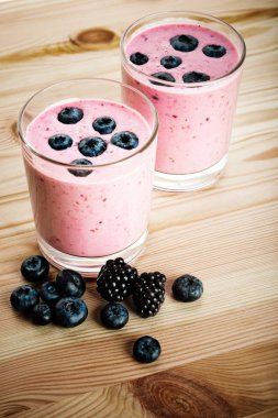 yaban mersini ve rustik ahşap masa üstünde böğürtlen ile güler yüzlü