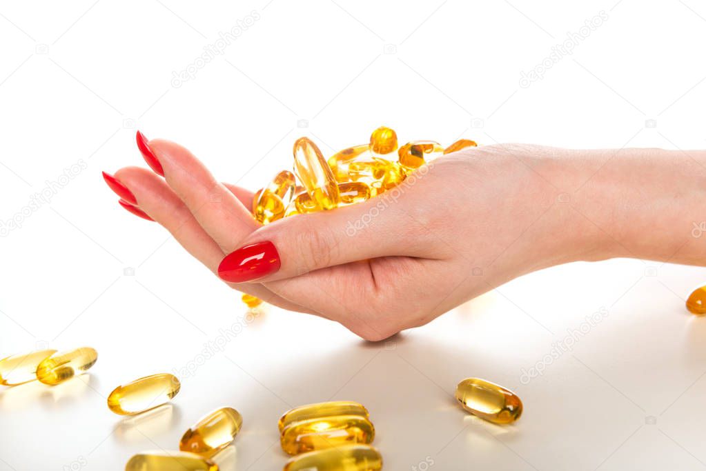 Vitamin Omega-3 fish oil capsules on a hand 