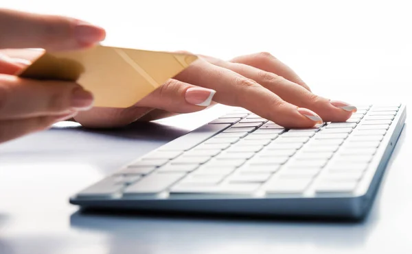 Hands holding a credit card and using laptop computer for online — Stock Photo, Image