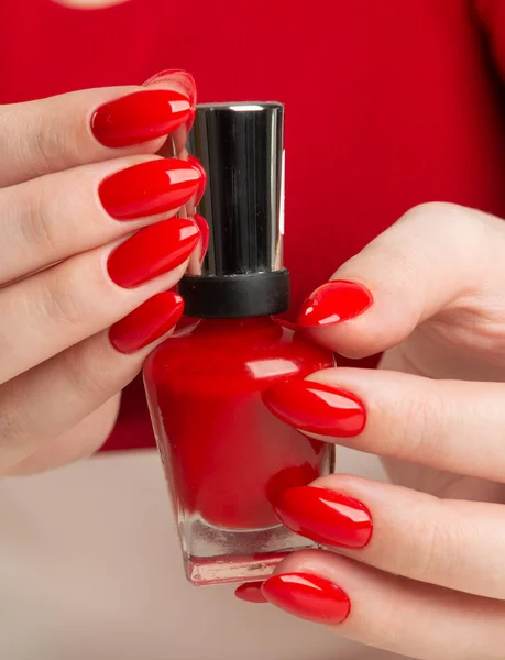 Female Hand Red Nail Polish Bottl Stock Image