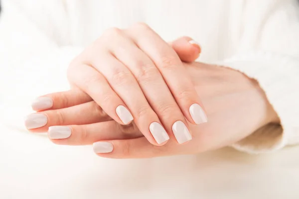 Beautiful female hand with beige nail design — Stock Photo, Image