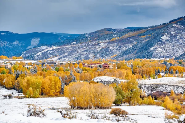 Season changing, first snow and autumn trees. Rocky Mountains, Colorado, USA.
