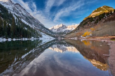 Kayalar ve kar dağlarda yansıması sonbahar içinde Colorado Rocky Dağları, ABD ile çan ve Maroon Gölü Bordo. 