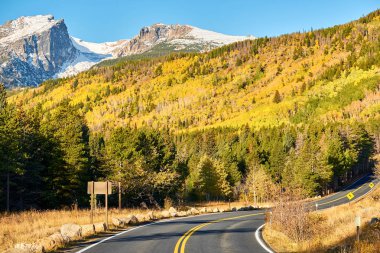 Rocky Dağı Ulusal Parkı 'nda sonbahar güneşli bir günde otoyol. Colorado, ABD. 